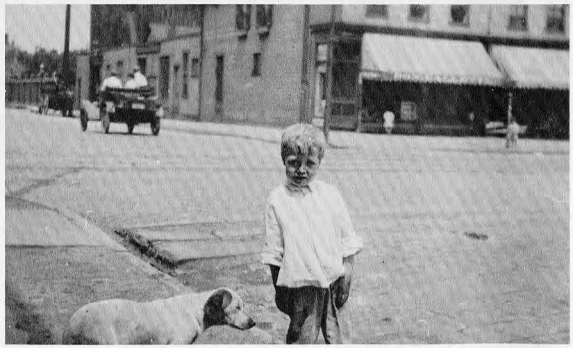 picture of boy and dog on sidewalk