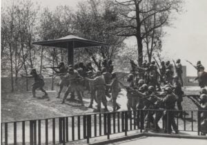 National Guardsmen pointing their guns and appearing to fire.