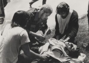 3 college students tending to an injured student who is laying down