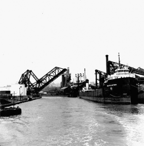 A jackknife bridge in the open position to allow passage of an ore boat on the Cuyahoga River.