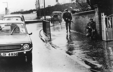 BELFAST SOLDIERS. British soldiers of the King’s Own Scottish Borderers take up defensive/observational positions at a traffic circle in Andersonstown, Belfast, as they patrol the streets. Their rifles are loaded, but they rarely wear helmets.