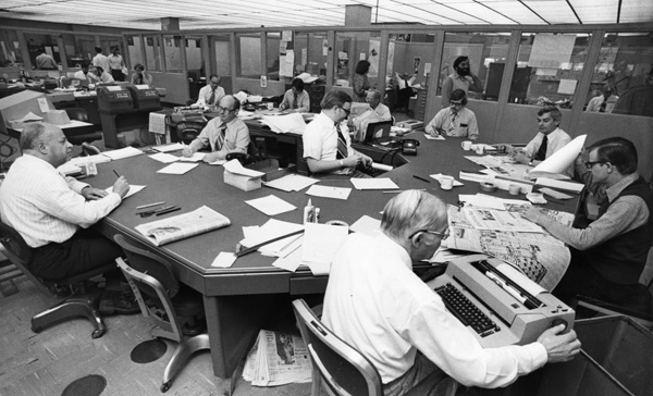 The windowless Press Copy Desk just before the age of computers. 1977. Center is Chief sub editor Dan Sabol, with deputy Bill Kjellstrand.