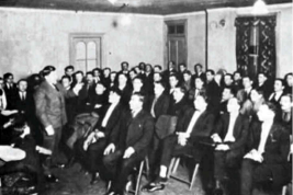 Two examples of the Americanization process in Cleveland: The "Melting Pot" float (1920) (above) and an English Language class for Italians taught by Mr. Charles Trivison, 1925 (below).