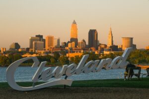 Photo of Cleveland sign in front of the Cleveland skyline