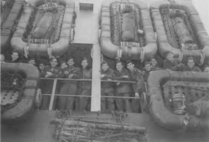 Author peaking over life raft on far right onboard the troop ship USS Admiral Eberle, returning home, Spring, 1946