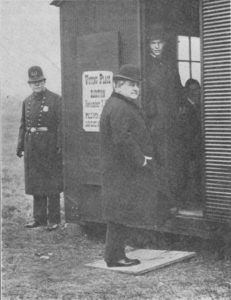 Tom L. Johnson entering voting booth, November 7, 1906