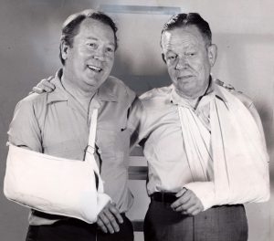 Posing with broken arms (really) in 1971 are Plain Dealer staffers George E. Condon, left, and Peter Bellamy. Bellamy, longtime drama critic, was the son of legendary Editor Paul Bellamy. Courtesy of Cleveland Public Library Photograph Collection.