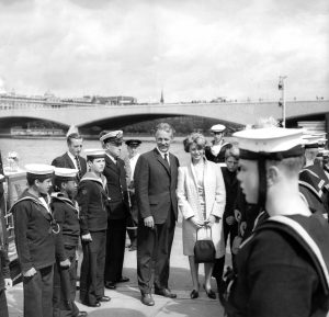 Robert Manry and his wife, Virginia, are piped ashore as they arrive at the Fesitval Hall in England in August 1965 for a luncheon in their honor. Photograph by William Ashbolt. Special Collections, Cleveland State University Library.