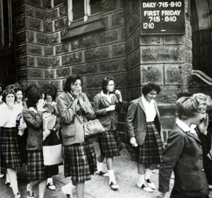 Students cry as they file out of St. Peters High School on Nov. 22, 1963, after hearing that President John F. Kennedy has been killed. Photograph by William "Bill" Wynne, Special Collections, Cleveland State University Library.