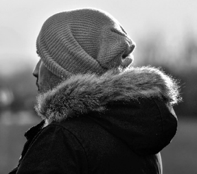 person with coat and knit hat