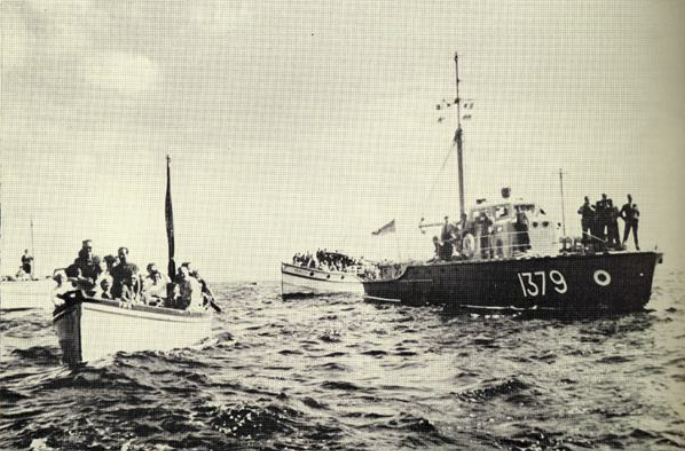 R.A.F. launch (right) and sightseers provide escort into Falmouth.