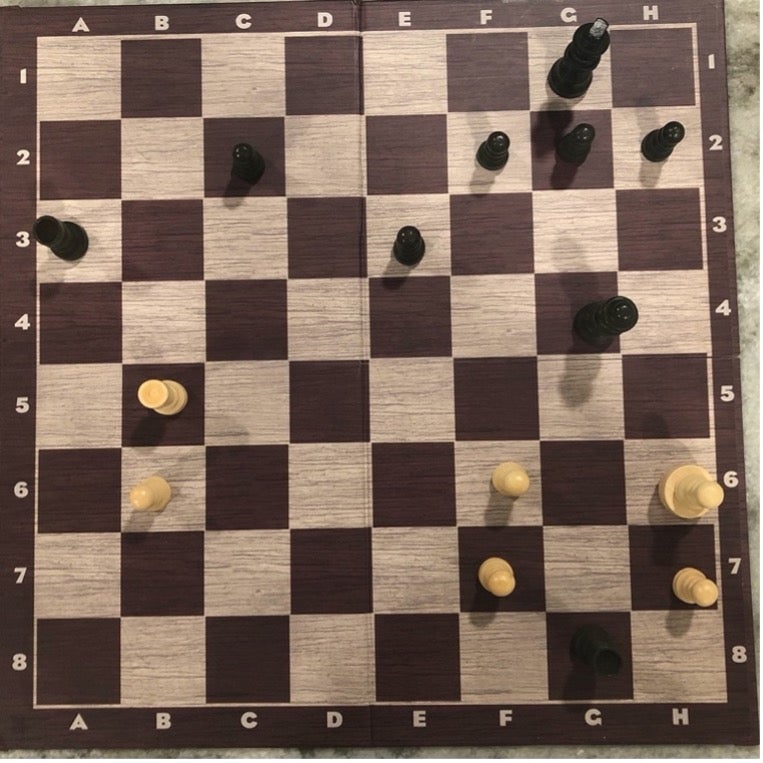 Lexica - Cyber Chess board with a hand about to hit the king down