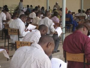 Students sitting at desks and taking exams.
