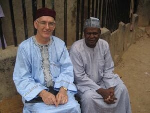 This book's editor wearing his new baba riga, the formal attire of Hausa men, next to the presenter, Dr. Salisu Abdullahi, a faculty colleague and former student.