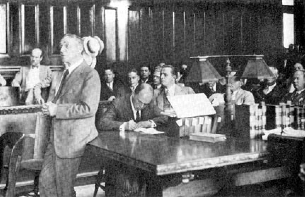 Newton D. Baker (standing left) defends Louis B. Seltzer (seated far right) (1929)